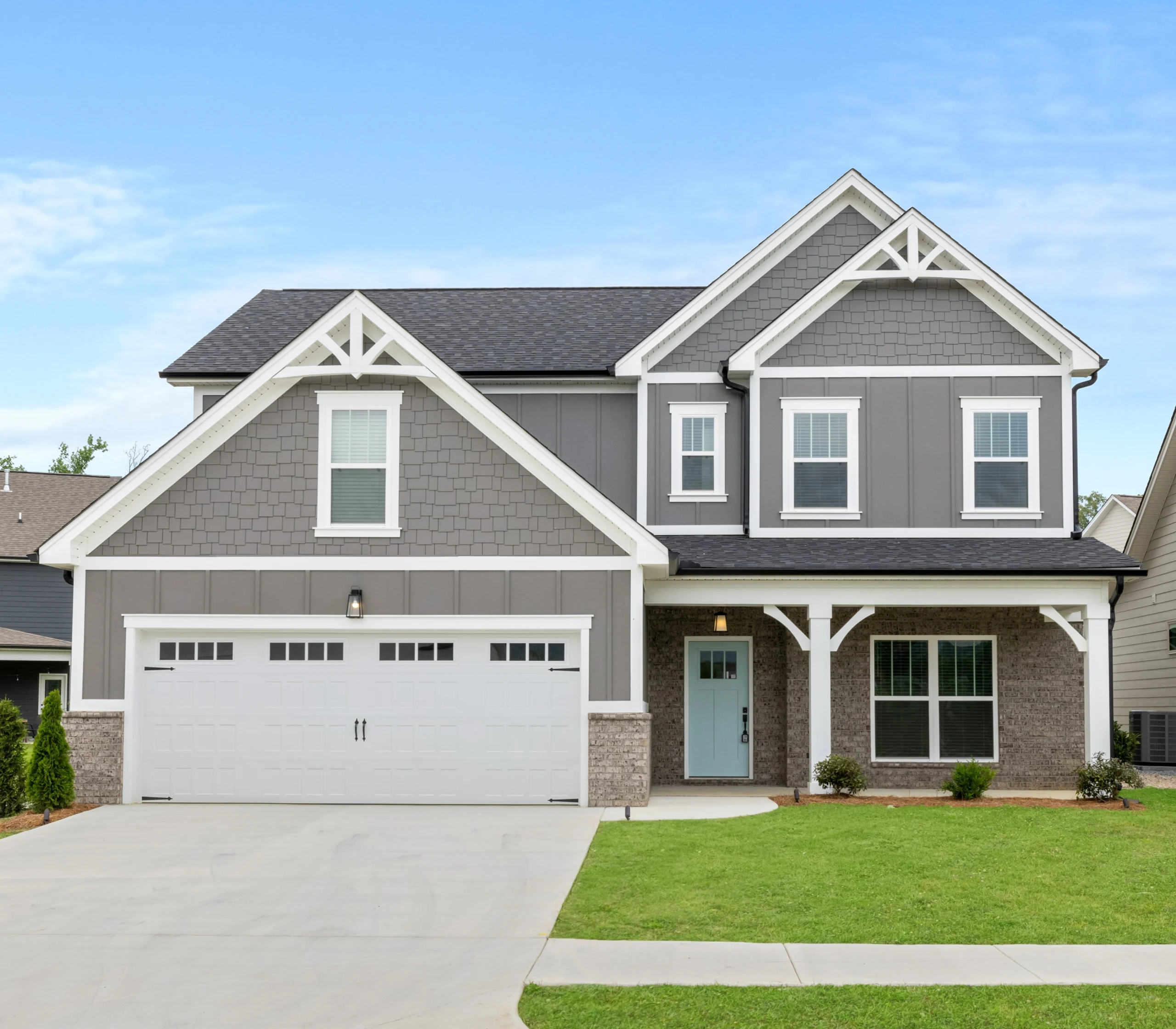 Peachtree-floor-plan-front-exterior-home-for-sale Modern two-story gray house with white trim, large garage, and manicured lawn by Pratt Home Builders in Chattanooga TN.
