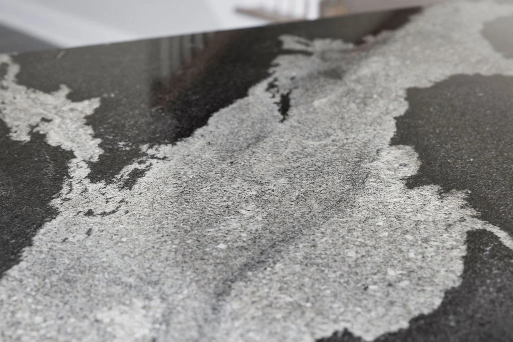 Polished granite countertop with intricate gray and black patterns, a feature by Pratt Home Builders in Chattanooga TN.