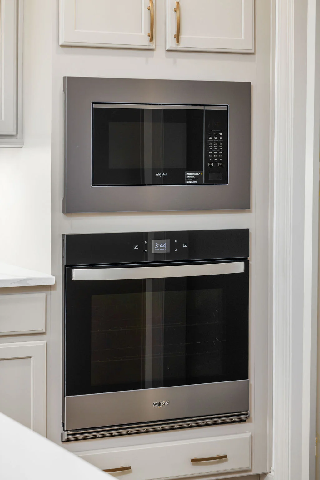 Stainless steel built-in microwave and oven in a modern kitchen by Pratt Home Builders in Chattanooga TN, featuring sleek cabinetry.