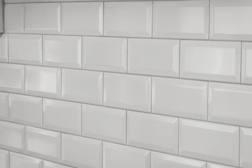 White subway tiles arranged in a brick pattern. Pratt Home Builders in Chattanooga TN.