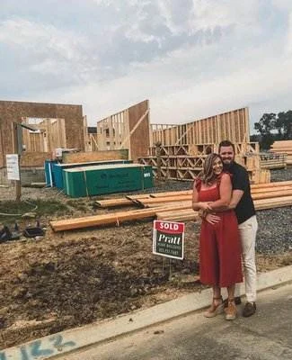 image003 Couple embraces in front of a home under construction with a Sold sign for Pratt Home Builders in Chattanooga TN.