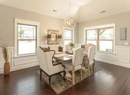 image005 Elegant dining room with white wainscoting, wooden floor, and large windows. Designed by Pratt Home Builders in Chattanooga TN.