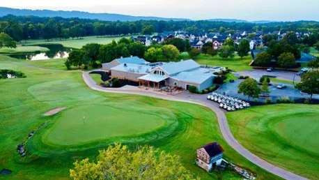 Ariel Clubhouse View Scenic golf course with lush greens and a clubhouse, surrounded by homes. A community possibly developed by Pratt Home Builders in Chattanooga TN.