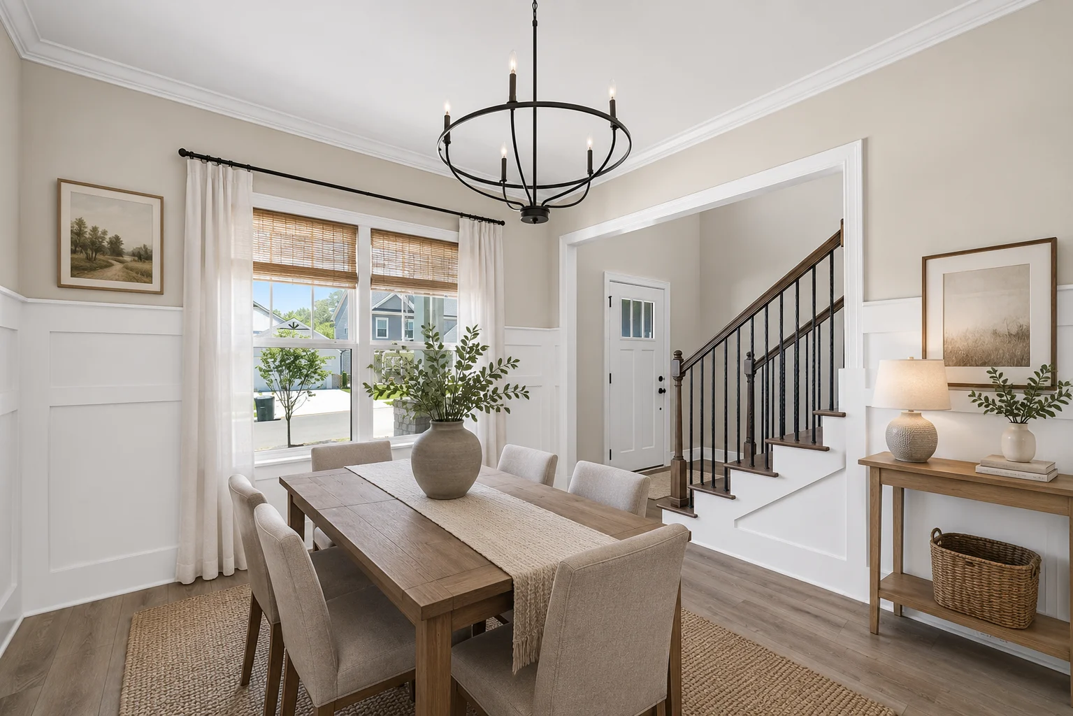 Elegant dining room with beige walls, wooden table, upholstered chairs, and a black chandelier. Designed by Pratt Home Builders in Chattanooga TN.
