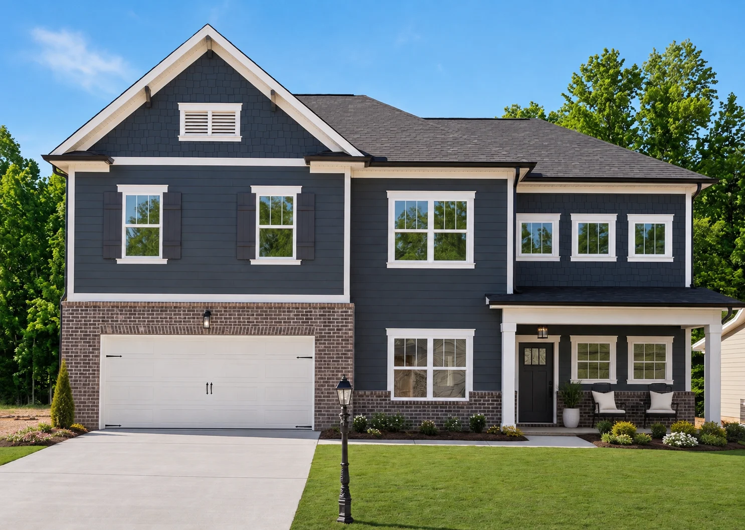 Two-story modern home by Pratt Home Builders in Chattanooga TN, featuring a dark facade, white trim, and a well-manicured lawn.