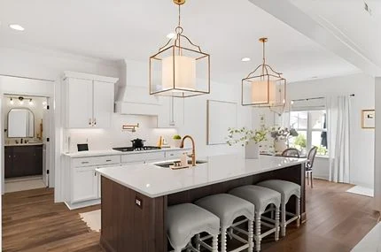 Modern kitchen with large island, elegant pendant lights, and white cabinetry by Pratt Home Builders in Chattanooga, TN.