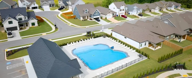 Aerial view of a suburban neighborhood in Chattanooga, TN, featuring a large community pool built by Pratt Home Builders, surrounded by homes and gree