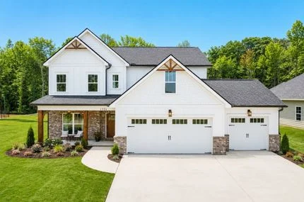 Pratt Living Blog Images (1) Two-story white house with stone accents, three-car garage, manicured lawn; built by Pratt Home Builders in Chattanooga TN.