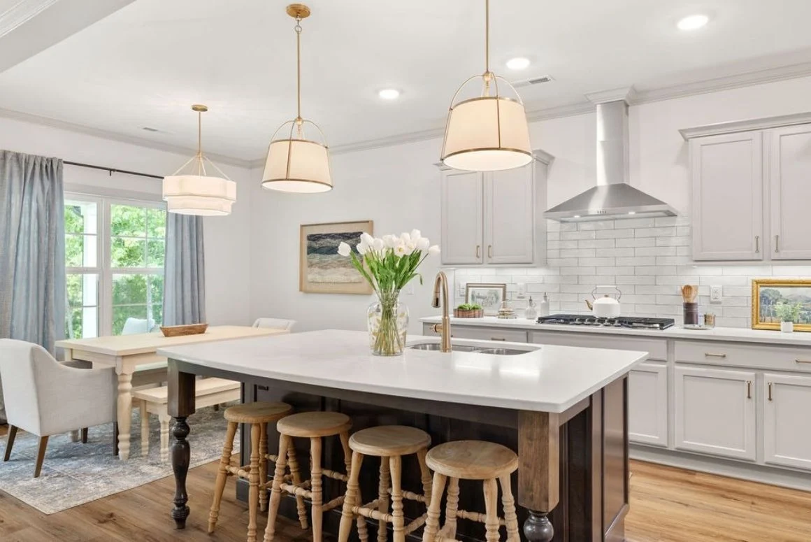 Pratt Living Blog Images Modern kitchen by Pratt Home Builders in Chattanooga, TN, features a central island, pendant lights, and a dining area with natural light.