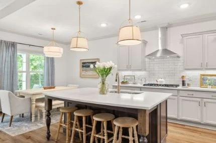 Pratt Living Blog Images (2) Modern kitchen by Pratt Home Builders in Chattanooga TN, featuring a large island, wicker stools, pendant lights, and a dining area with natural light